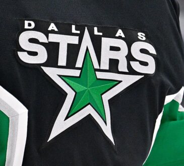 The Dallas Stars crest, a green star ringed in white, stitched on goaltender Jake Oettinger's black jersey.
