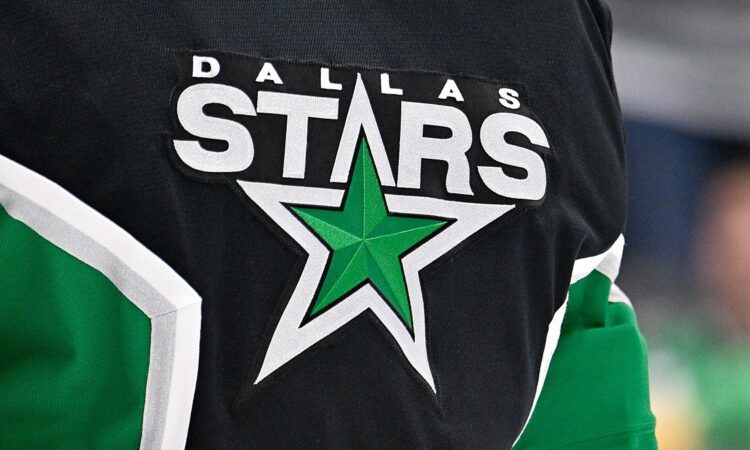 The Dallas Stars crest, a green star ringed in white, stitched on goaltender Jake Oettinger's black jersey.