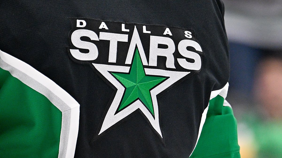 The Dallas Stars crest, a green star ringed in white, stitched on goaltender Jake Oettinger's black jersey.
