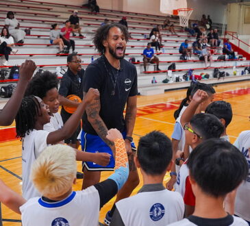 Dallas Mavericks center Dereck Lively II fires up a huddle of young campers at a Mavs Academy hoop camp.