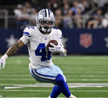 Dallas Cowboys running back Deuce Vaughn plants and cuts with the ball at AT&T Stadium.