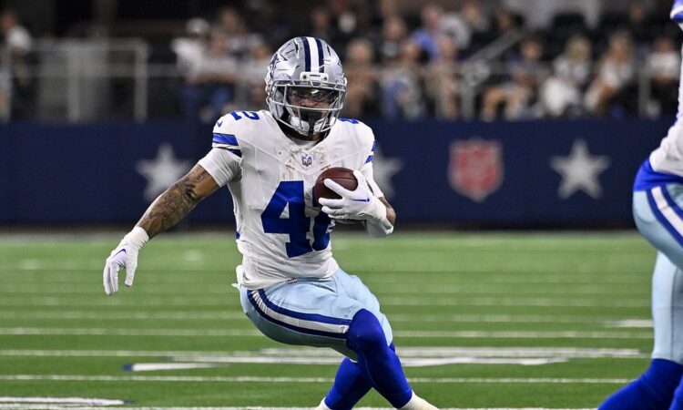 Dallas Cowboys running back Deuce Vaughn plants and cuts with the ball at AT&T Stadium.