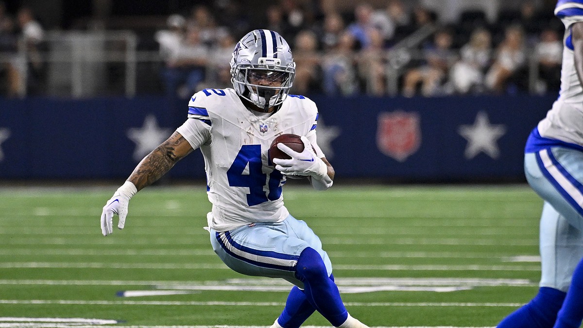 Dallas Cowboys running back Deuce Vaughn plants and cuts with the ball at AT&T Stadium.
