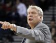 Golden State Warriors head coach Don Nelson points and calls out an instruction to his team from the sideline.