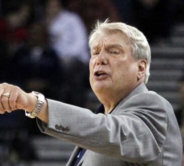 Golden State Warriors head coach Don Nelson points and calls out an instruction to his team from the sideline.