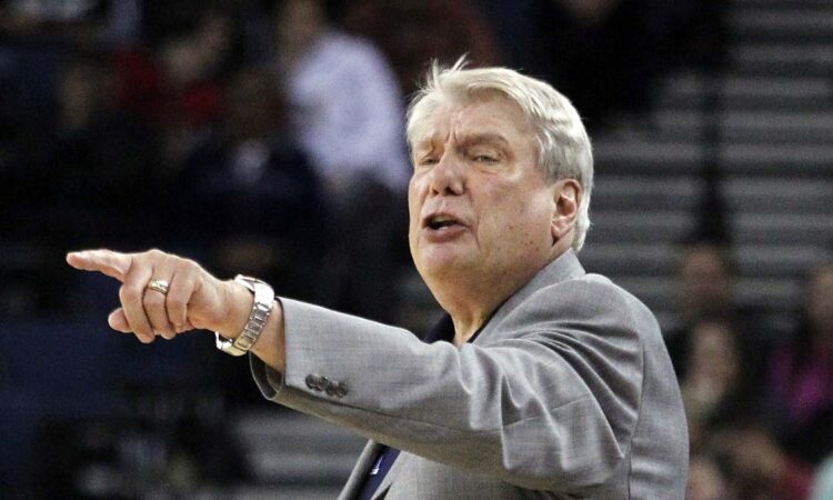 Golden State Warriors head coach Don Nelson points and calls out an instruction to his team from the sideline.