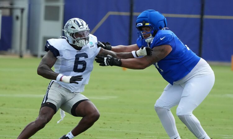 Dallas Cowboys outside linebacker Donovan Ezeiruaku fights the hands of Los Angeles Rams offensive tackle Alaric Jackson during a pass-rush rep.