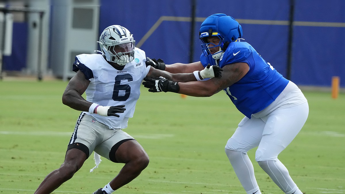 Dallas Cowboys outside linebacker Donovan Ezeiruaku fights the hands of Los Angeles Rams offensive tackle Alaric Jackson during a pass-rush rep.