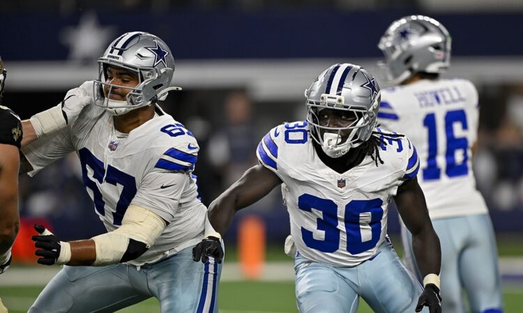 Dallas Cowboys offensive tackle Drew Shelton and running back Israel Abanikanda block in front of the quarterback against the Saints.