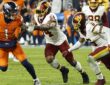Denver Broncos tight end Evan Engram carries the ball as Commanders linebacker Bobby Wagner reaches for him from behind.