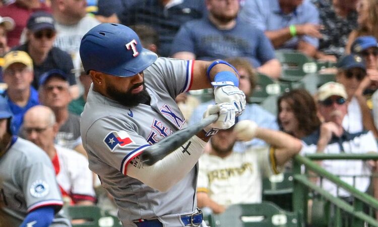 Texas Rangers batter Ezequiel Durán drives a pitch in his gray road uniform at American Family Field.