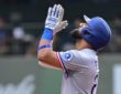 Texas Rangers batter Ezequiel Durán raises his hands and looks skyward after reaching base at American Family Field.