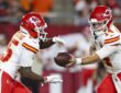 Kansas City Chiefs quarterback Garrett Nussmeier hands the ball to running back Emari Demercado in a preseason game.