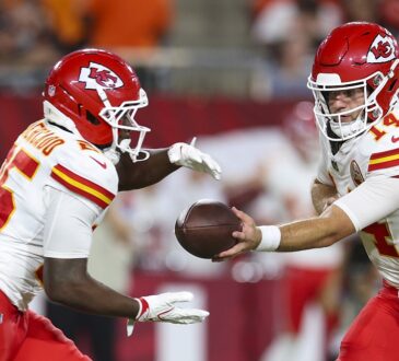 Kansas City Chiefs quarterback Garrett Nussmeier hands the ball to running back Emari Demercado in a preseason game.