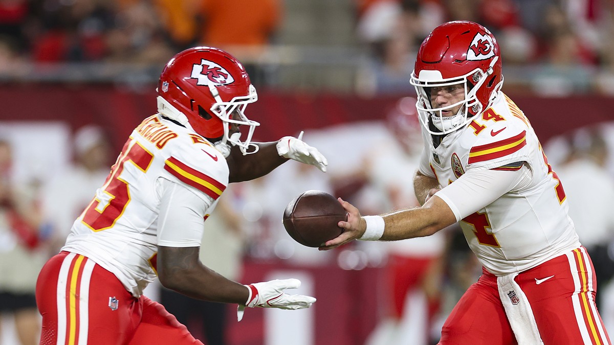 Kansas City Chiefs quarterback Garrett Nussmeier hands the ball to running back Emari Demercado in a preseason game.