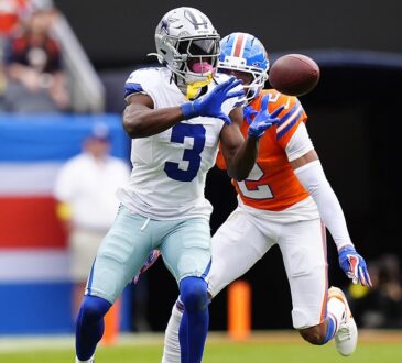 Dallas Cowboys wide receiver George Pickens hauls in a catch as Broncos cornerback Patrick Surtain II defends.