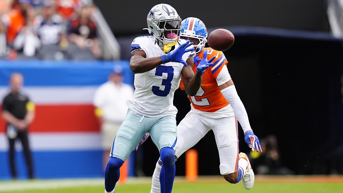 Dallas Cowboys wide receiver George Pickens hauls in a catch as Broncos cornerback Patrick Surtain II defends.