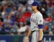 Rangers pitcher Jacob deGrom releases a pitch from the mound in a home white uniform