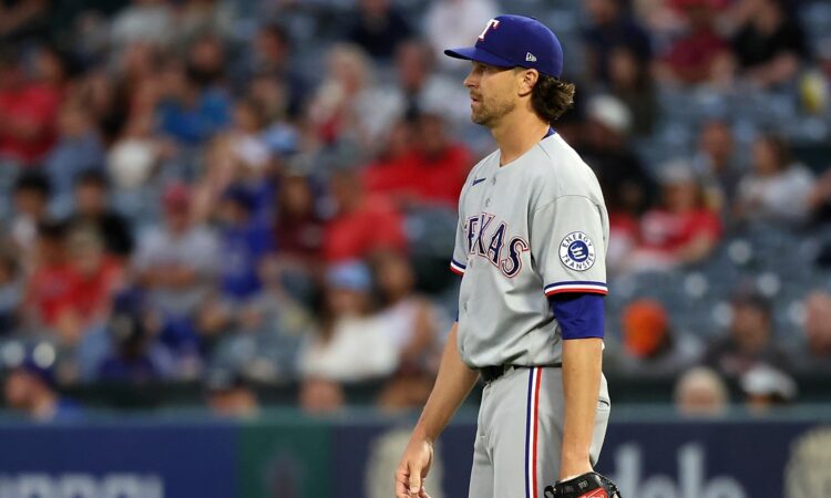 Rangers pitcher Jacob deGrom releases a pitch from the mound in a home white uniform