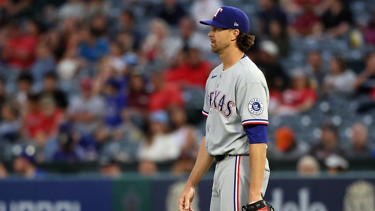 Rangers pitcher Jacob deGrom releases a pitch from the mound in a home white uniform