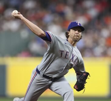 Texas Rangers starting pitcher Jacob deGrom delivers a pitch in his gray road uniform against the Astros.