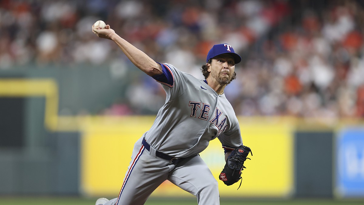 Texas Rangers starting pitcher Jacob deGrom delivers a pitch in his gray road uniform against the Astros.