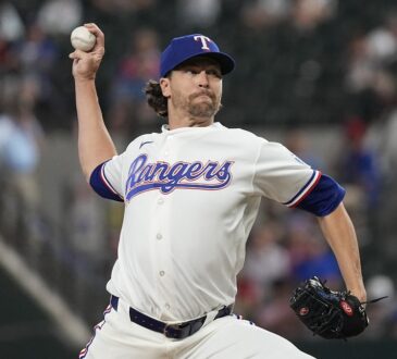 Texas Rangers starting pitcher Jacob deGrom releases a pitch in his white home uniform at Globe Life Field.