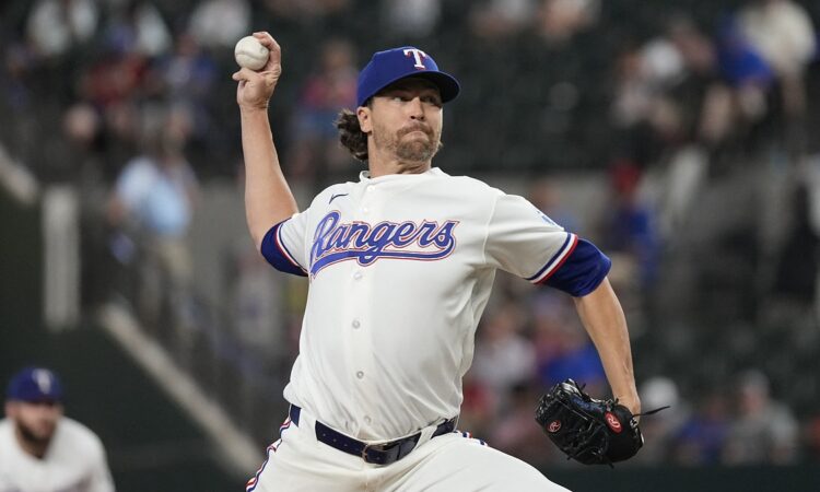 Texas Rangers starting pitcher Jacob deGrom releases a pitch in his white home uniform at Globe Life Field.