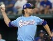 Texas Rangers starting pitcher Jacob deGrom rears back to throw in the powder blue Sunday jersey.