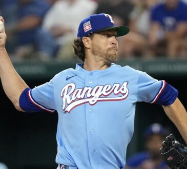 Texas Rangers starting pitcher Jacob deGrom rears back to throw in the powder blue Sunday jersey.