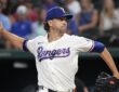 Rangers pitcher Jacob deGrom releases a pitch from the mound in a home white uniform