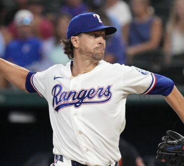 Rangers pitcher Jacob deGrom releases a pitch from the mound in a home white uniform
