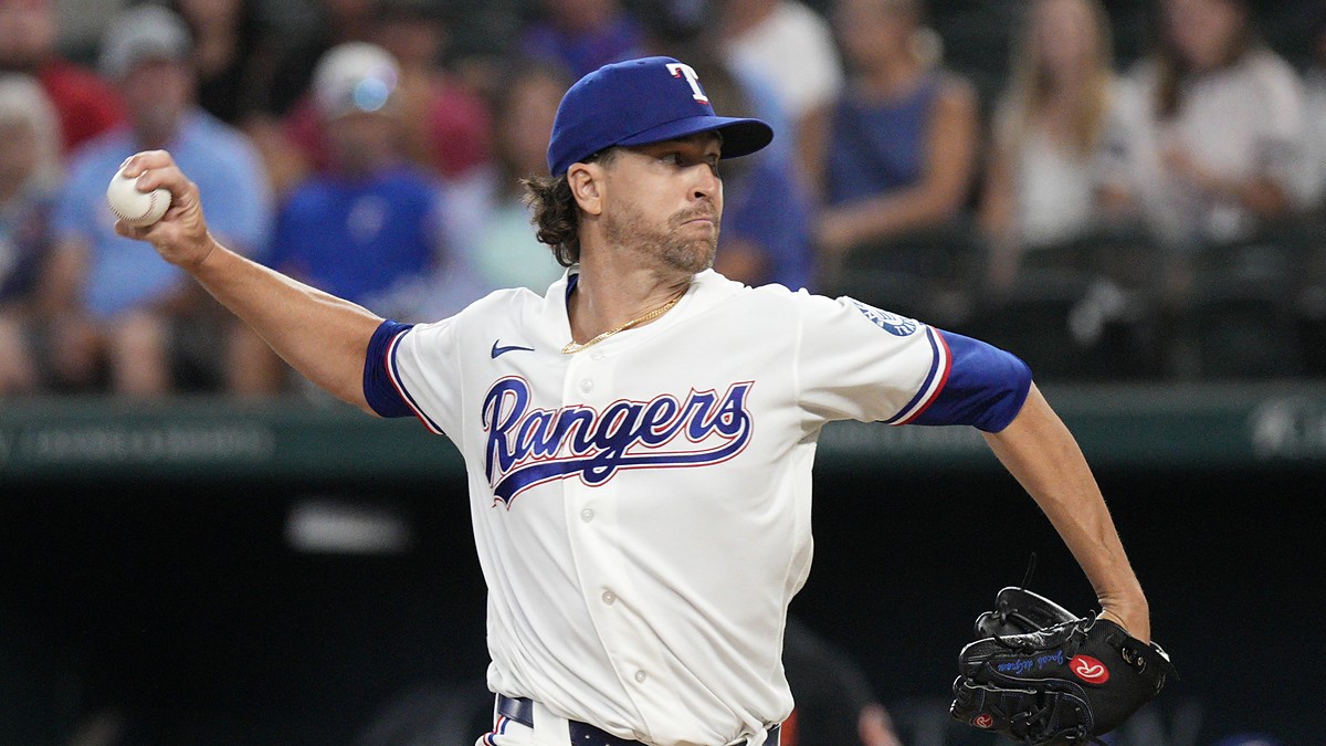 Rangers pitcher Jacob deGrom releases a pitch from the mound in a home white uniform