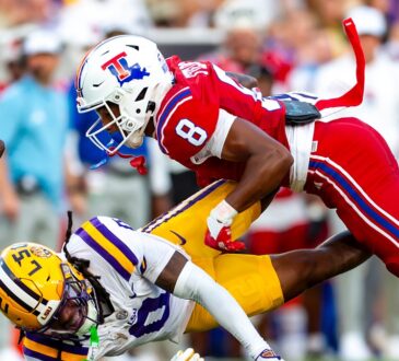 Louisiana Tech defensive back Jacob Fields dives into LSU wide receiver Zavion Thomas, knocking the ball loose.
