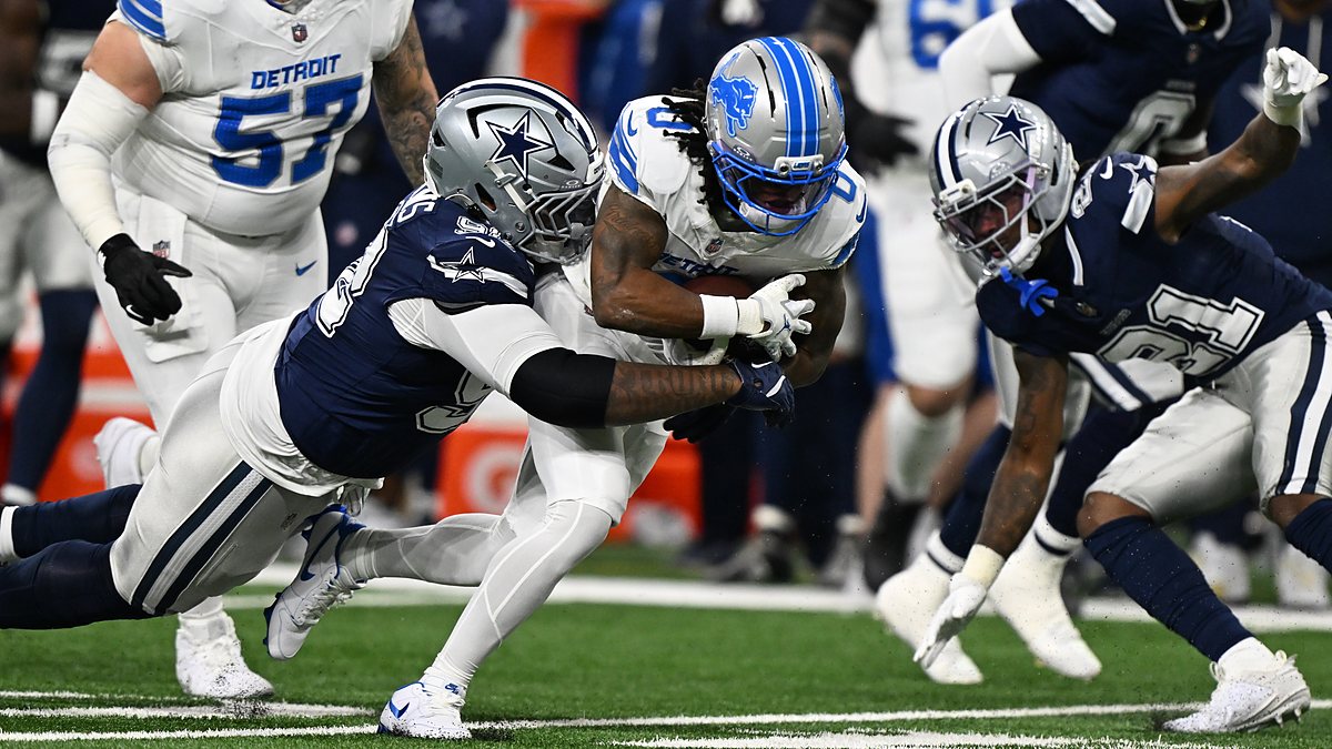 Detroit Lions running back Jahmyr Gibbs is wrapped up by Dallas Cowboys defensive tackle Quinnen Williams on a run.