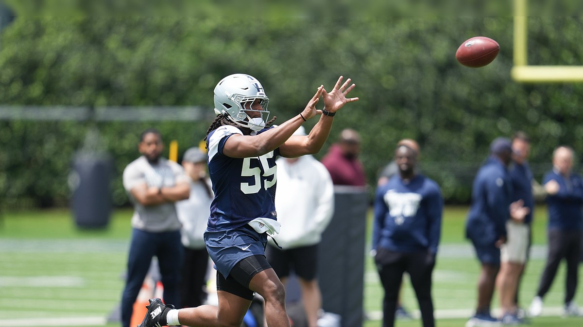 Dallas Cowboys linebacker Jaishawn Barham reaches out to catch a football during a rookie minicamp drill.
