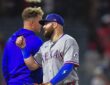 Texas Rangers first baseman Jake Burger smiles and bumps fists with a teammate after a win at Angel Stadium.