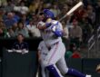 Texas Rangers first baseman Jake Burger follows through on his swing after connecting against the Athletics.