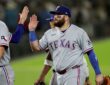 Texas Rangers first baseman Jake Burger high fives a teammate after a win at Sutter Health Park.