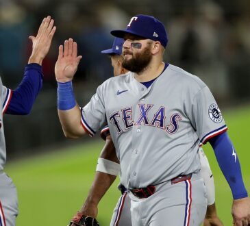Texas Rangers first baseman Jake Burger high fives a teammate after a win at Sutter Health Park.