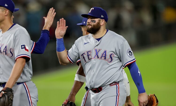 Texas Rangers first baseman Jake Burger high fives a teammate after a win at Sutter Health Park.