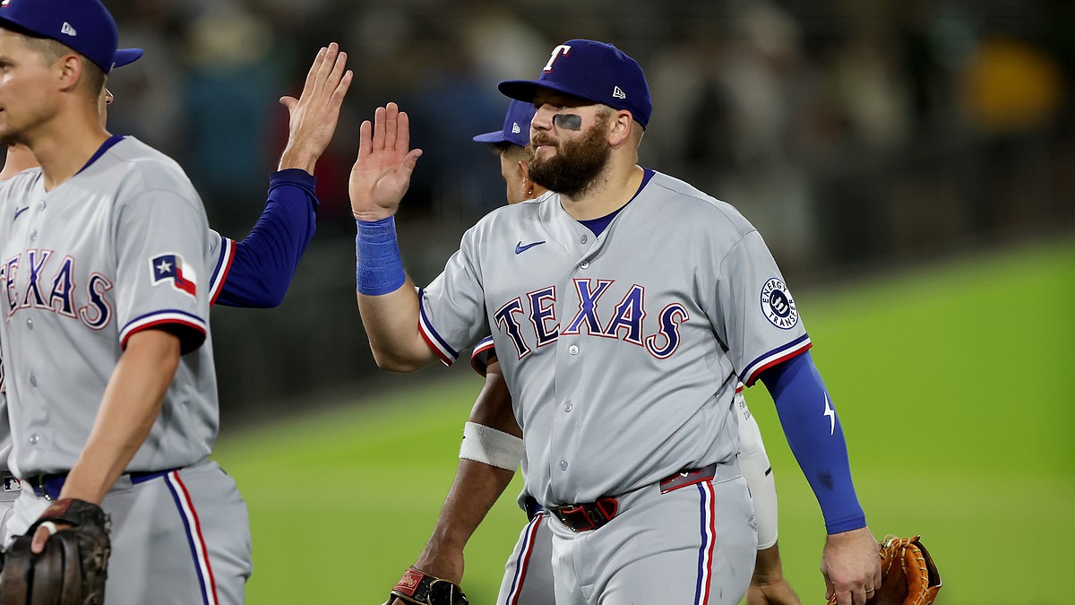 Texas Rangers first baseman Jake Burger high fives a teammate after a win at Sutter Health Park.