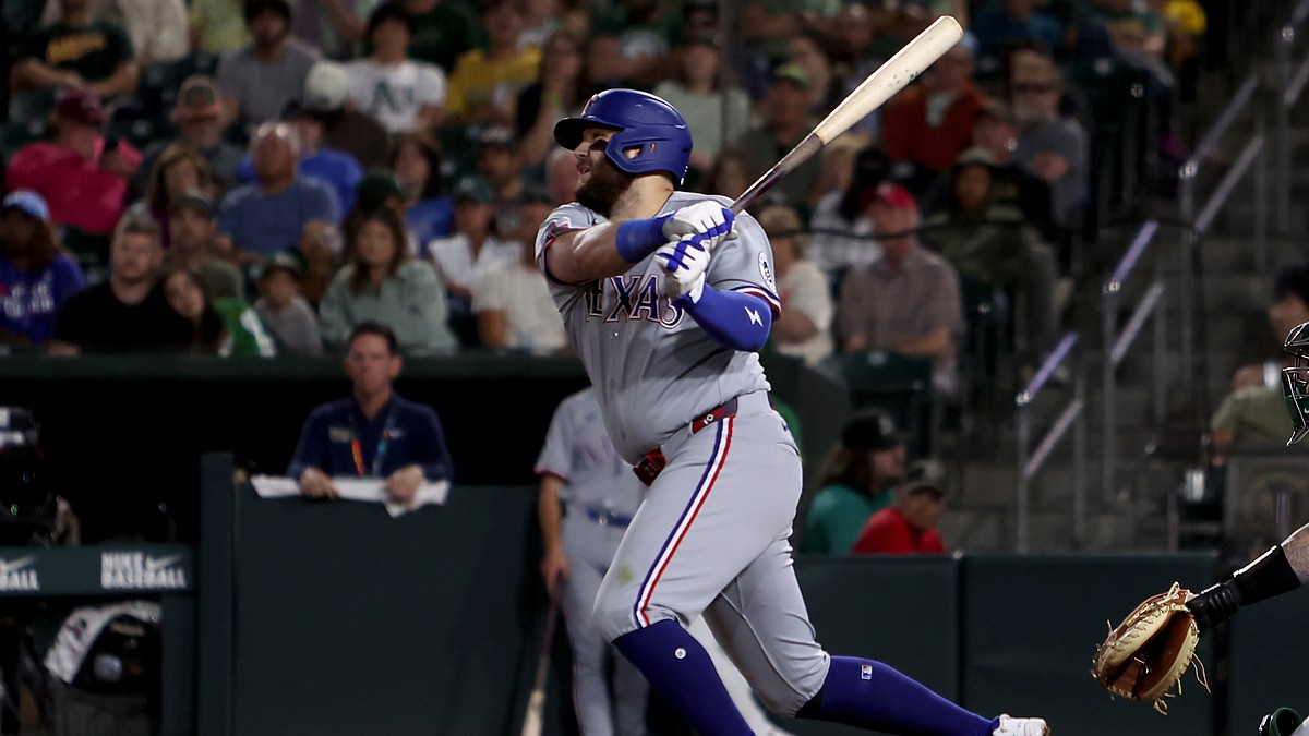 Texas Rangers first baseman Jake Burger follows through on his swing after connecting against the Athletics.