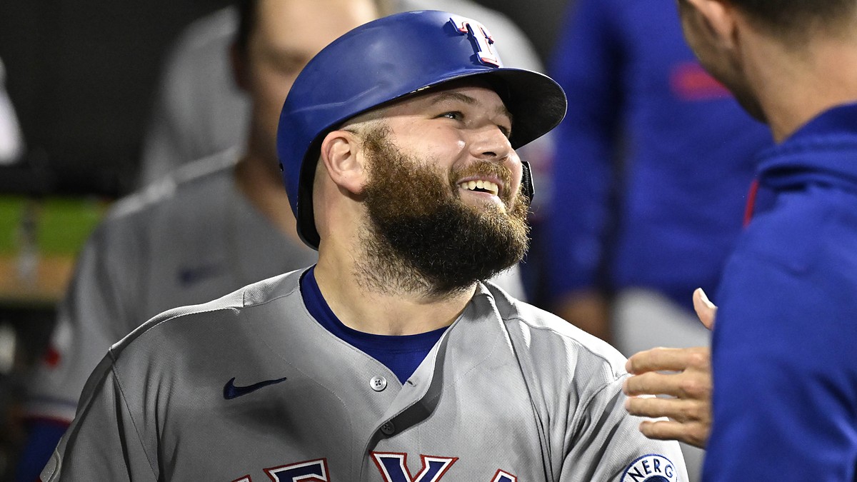 Texas Rangers first baseman Jake Burger smiles in the dugout after a home run against the White Sox.