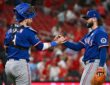 Texas Rangers relief pitcher Jakob Junis clasps hands with catcher Danny Jansen after closing out a win.
