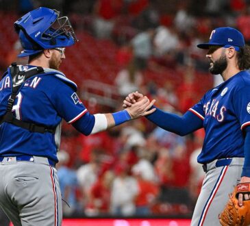 Texas Rangers relief pitcher Jakob Junis clasps hands with catcher Danny Jansen after closing out a win.