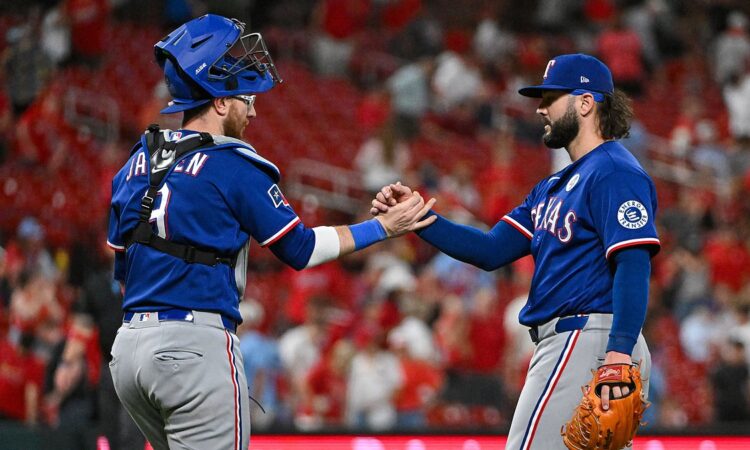 Texas Rangers relief pitcher Jakob Junis clasps hands with catcher Danny Jansen after closing out a win.
