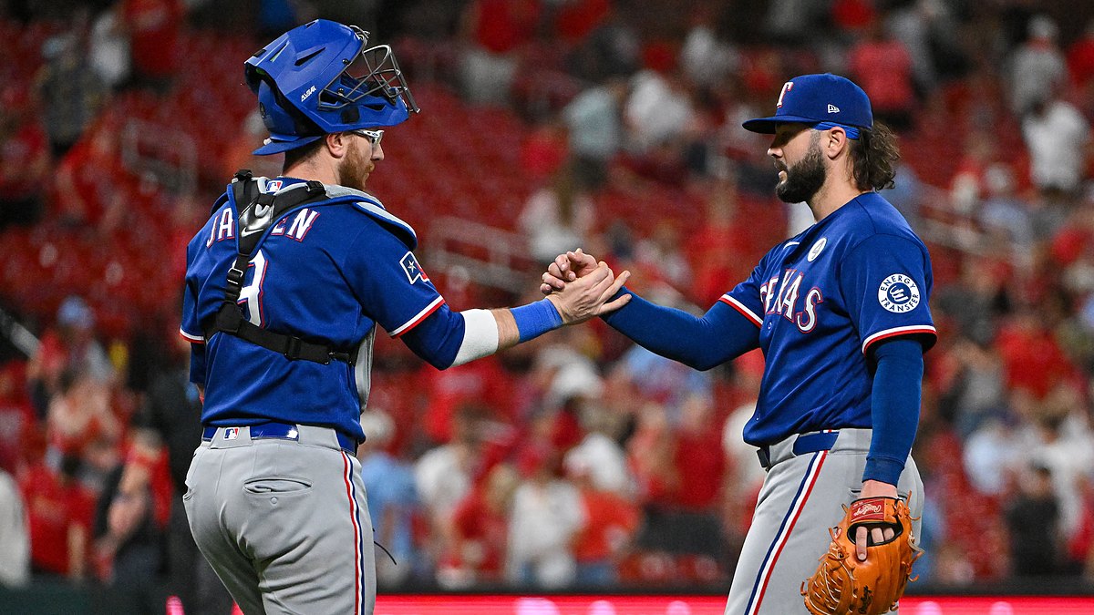 Texas Rangers relief pitcher Jakob Junis clasps hands with catcher Danny Jansen after closing out a win.