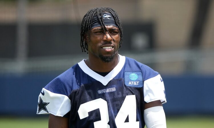 Dallas Cowboys safety Jalen Thompson stands on the practice field in a navy No. 34 practice jersey.