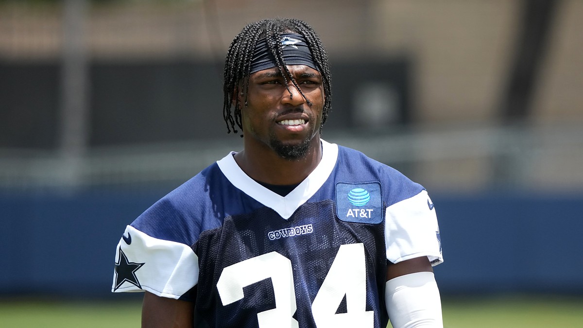 Dallas Cowboys safety Jalen Thompson stands on the practice field in a navy No. 34 practice jersey.